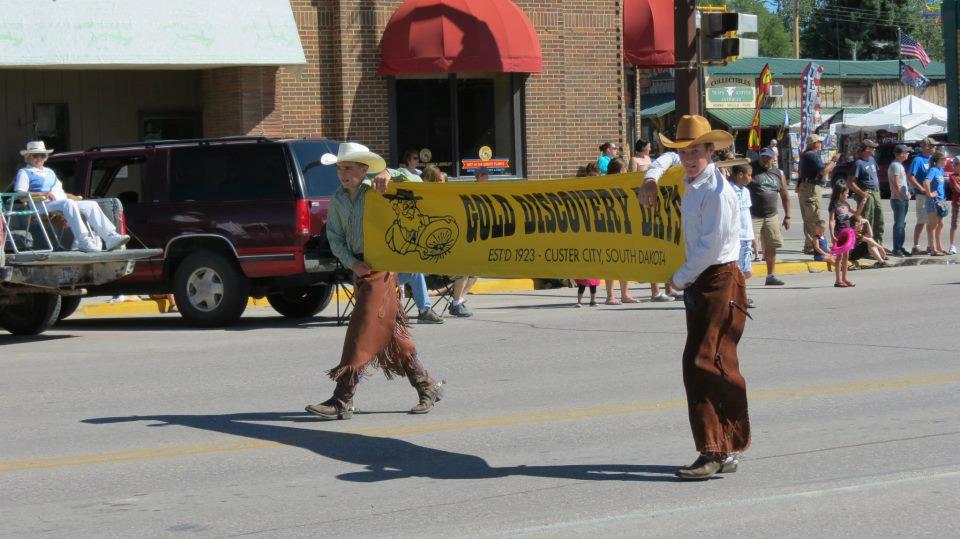 2 guys holding banner at gold discovery days