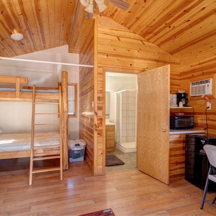 Interior view of wooden cabin with bunk beds at Beaver Lake Campground